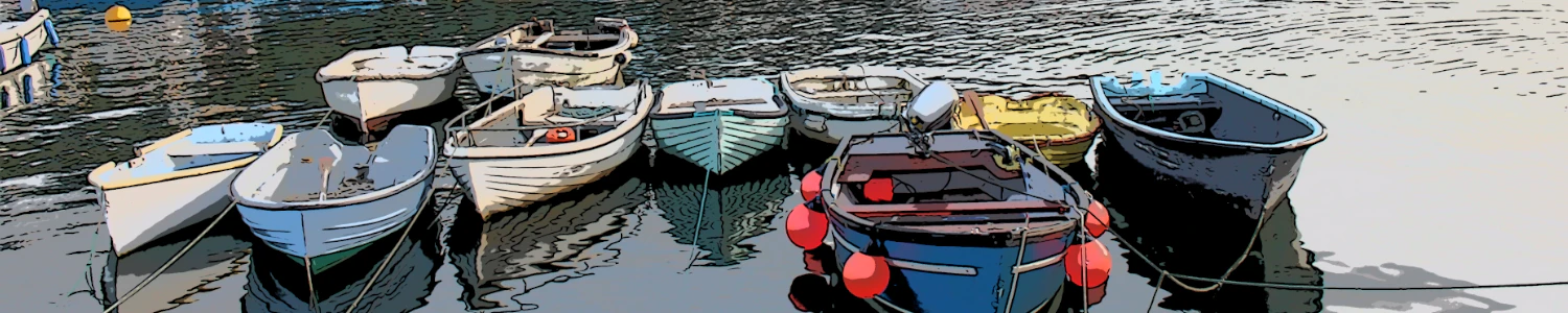 mevagissey harbour in devon with several colourful small boats on the water